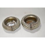 Two African Manilla bracelets in silver tone metal, having had brass liners added at a later date to