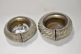 Two African Manilla bracelets in silver tone metal, having had brass liners added at a later date to