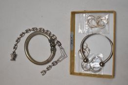 A selection of silver tone bangles and chains.