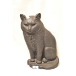 A large cast iron door stop in the form of a cat.