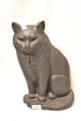A large cast iron door stop in the form of a cat.