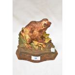 A vintage cast iron door stop in the form of a frog, age related patina.