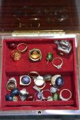 A modern lockable musical jewellery case with a selection of modern costume jewellery rings