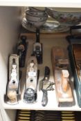 A selection of woodworking planes including Stanley, metal spoke shave and block plane