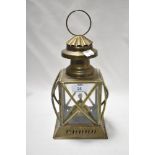 A vintage brass paraffin lantern with glass panels to sides.