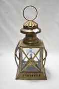 A vintage brass paraffin lantern with glass panels to sides.