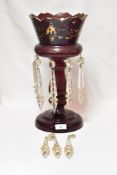 A Victorian ruby glass table lustre, with gilt heightening (worn) having five clear glass drops.