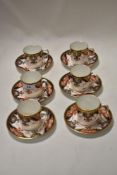 Six Royal Crown Derby coffee cans and saucers, having cobalt Blue and Rust Flower decoration with