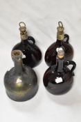 A pair of early Victorian amber glass onion decanters having etched silver tone collars and cork