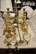 A selection of brass wares including two table lamps, two pairs of candle sticks and horse brasses