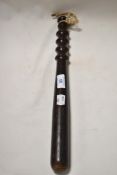 A vintage stained wooden truncheon having ribbed handle.