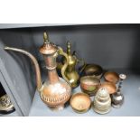 A mixed lot of Middle Eastern metal ware, including copper water jug, Brass Dallah coffee pot, bowls