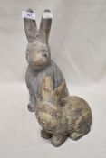 Four ornamental animal figures including two concrete cast rabbits, two wire work sheep