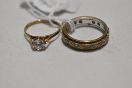 A 9ct gold eternity ring, size P and solitaire ring, size L, both having cubic zirconia stones,
