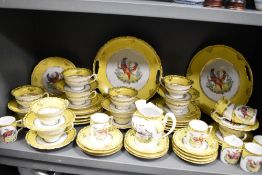 A large collection of 20th century yellow and white table wear having Chelsea style bird design