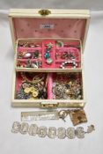 A jewellery box containing a selection of vintage costume jewellery, including loose beads, rings,
