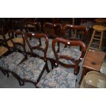 A set of six Victorian mahogany balloon back dining chairs with later upholstered seats