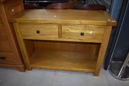 A modern golden oak hall or side table with double drawer and undershelf, width approx. 110cm