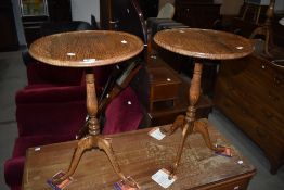 A pair of period style oak occasional tables having circular top, turned colum and triple splay
