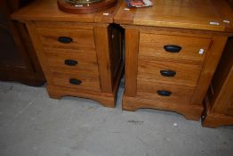 A pair of modern golden oak bedside chests of drawers