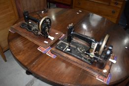 Two Victorian hand crank sewing machines