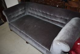 A late 19th or early 20th Century drop end settee having button back upholstery