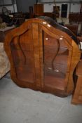 An Art Deco walnut china cabinet having shaped design