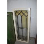 A pair of vintage painted pine windows with leaded glass panes