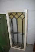 A pair of vintage painted pine windows with leaded glass panes