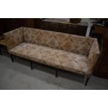 A late Victorian settle having turned mahogany legs and floral upholstery, width approx. 197cm