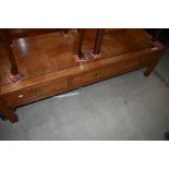 An Oriental hardwood coffee table having frieze drawers, approx. 153 x 56cm