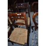 A pair of Victorian stained frame rail back kitchen chairs with later strung seats