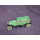 A 1930's Chad Valley clockwork and tinplate saloon car in green with black guards and silver