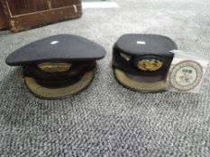 Two Station Master Peaked Caps both having embroidered badges along with a FW Grenadierdiv Bohmen-