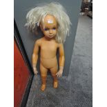 A vintage Child Shop Mannequin wearing a wig, height approx 80cm