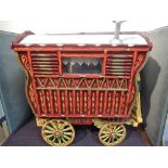 A hand made wooden model Gypsy Bow Top Caravan having hand painted decoration in the traditional