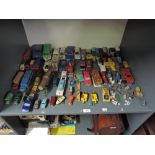 A shelf of playworn diecasts including Dinky 221 Corvette Stingray on card stand, Corgi Whizz Wheels