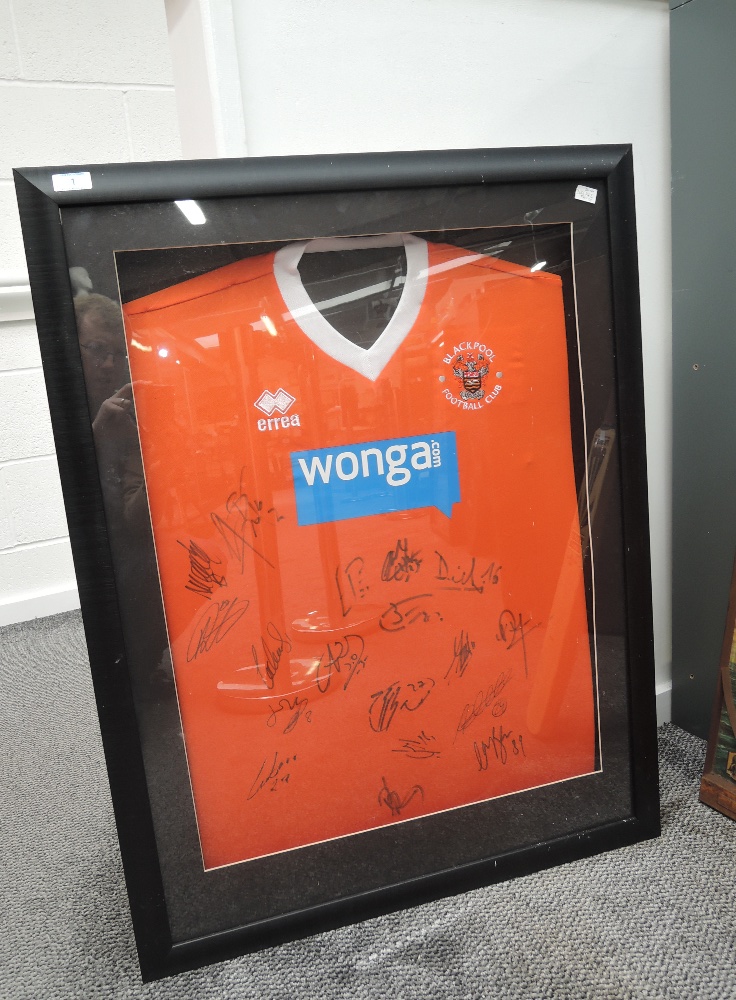 A Blackpool FC 2013-2015 Replica Home Shirt, bearing 18 signatures from the players, framed and