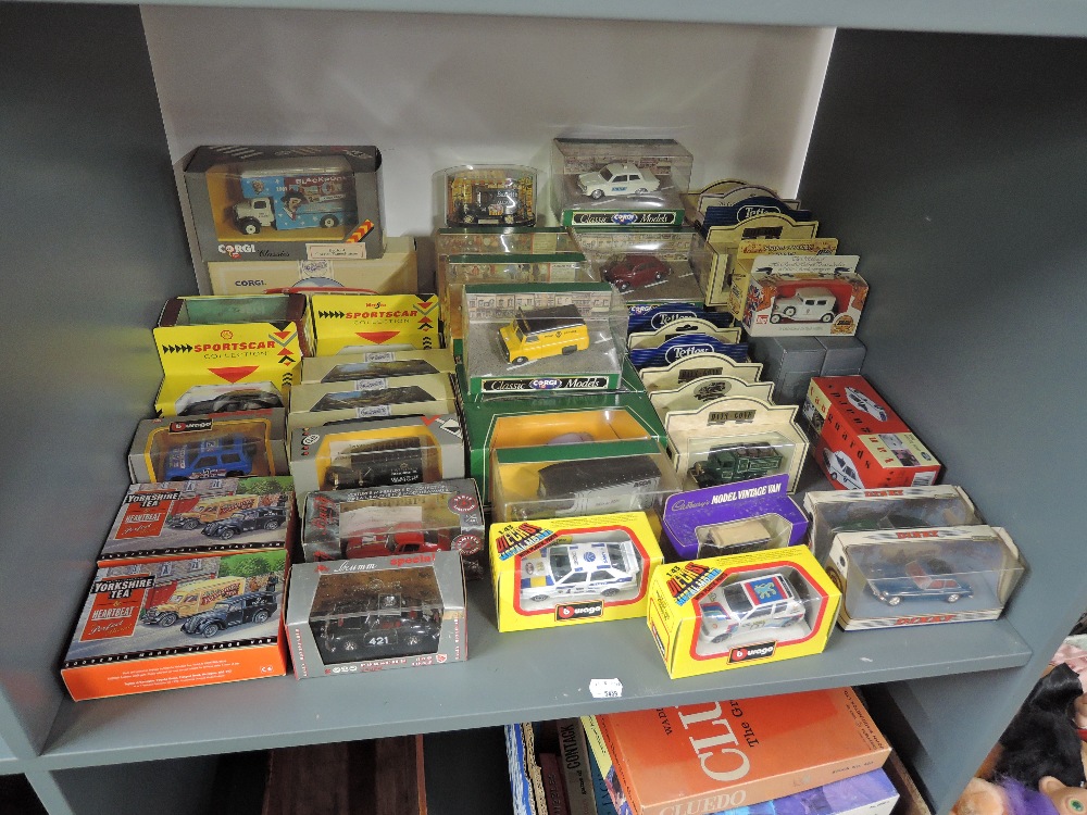 A shelf of modern diecasts including Dinky, Vanguards, Corgi Classics, Burago etc, all boxed