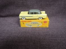 A Dinky diecast, 174 Hudson Hornet Sedan, Yellow & Grey in original correct spot box