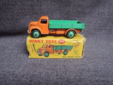 A Dinky diecast, 414 Dodge Rear Tipping Wagon, Orange & Green, in original correct spot box