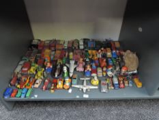 A shelf of playworn diecasts including Corgi Disney Series, Dinky Construction and Cars, Lesney,