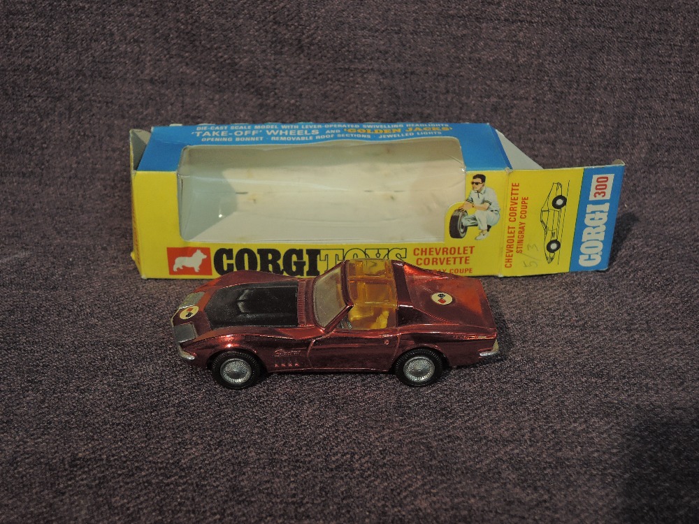 A Corgi diecast, 300 Chevrolet Corvette Stingray Coupe in metallic red with yellow interior, in