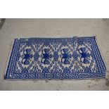 A blue and grey Turkish style flat weave rug.