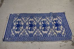 A blue and grey Turkish style flat weave rug.