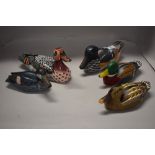 Five decorative wooden duck studies.