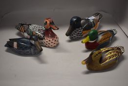 Five decorative wooden duck studies.