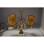 A vintage table lamp having lustre drops and twin candelabra style light fittings with paper