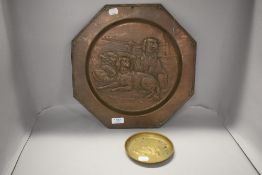 An early 20th century copper wall plaque depicting two Spaniel dogs and game hunt, along with a