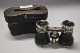 A vintage pair of small sized binoculars no makers name found and having fitted case